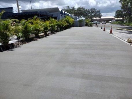 semi finished cement sidewalk with plants