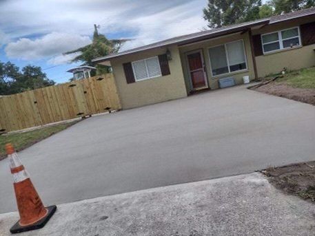 light yellow house with wooden gate after cement