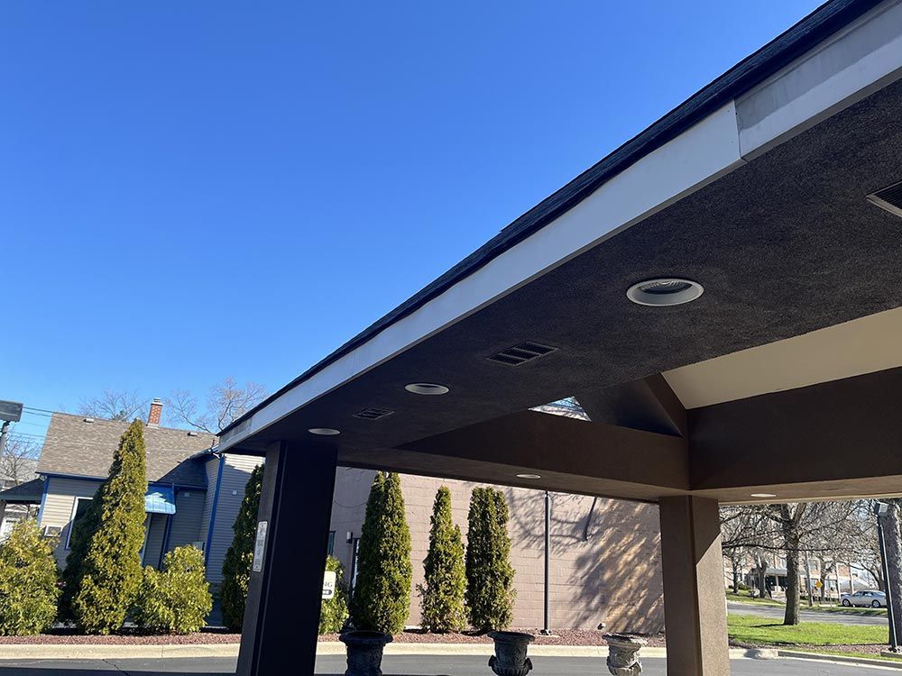 The roof of a building with a blue sky in the background