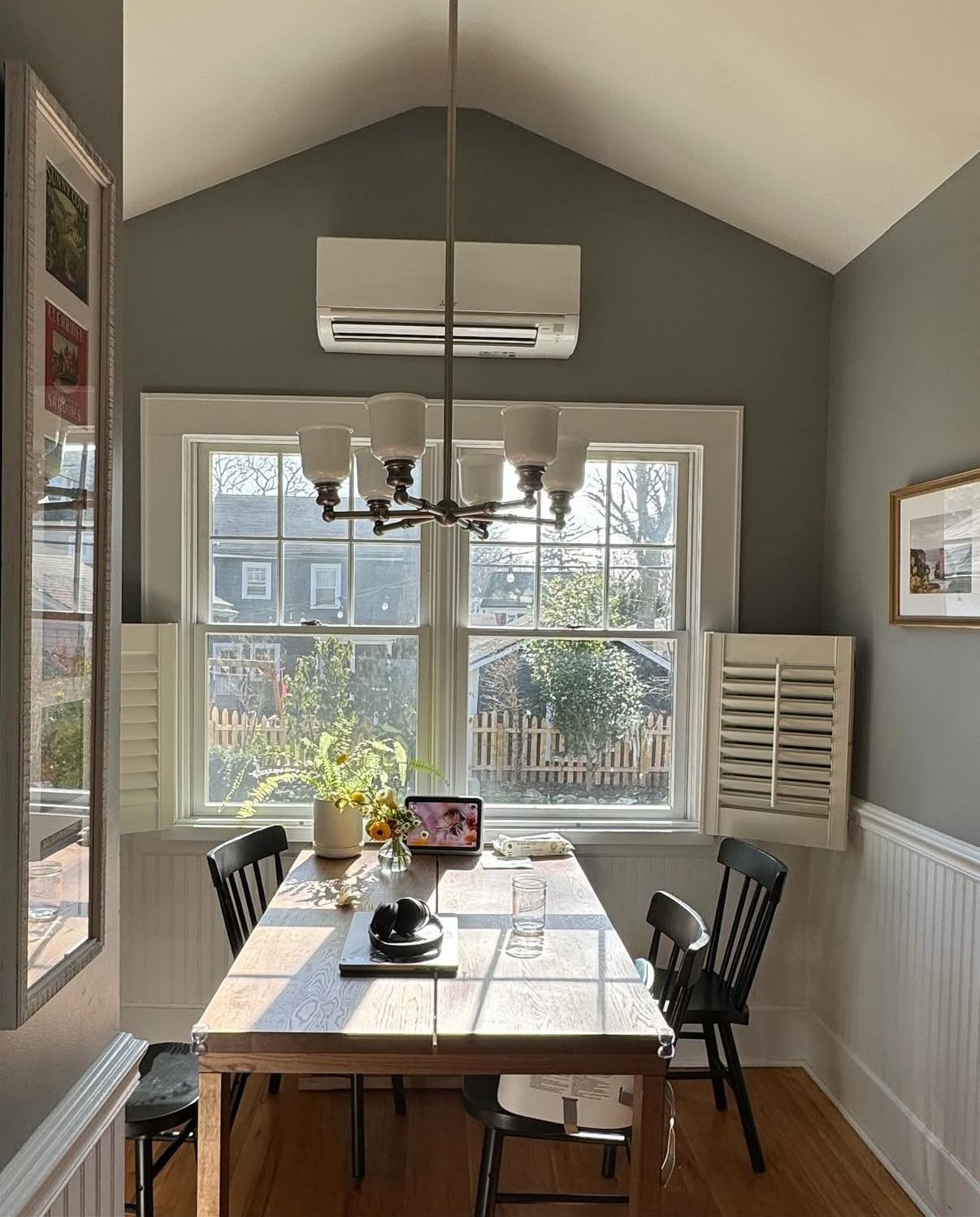 A dining area with a split-type AC on the wall