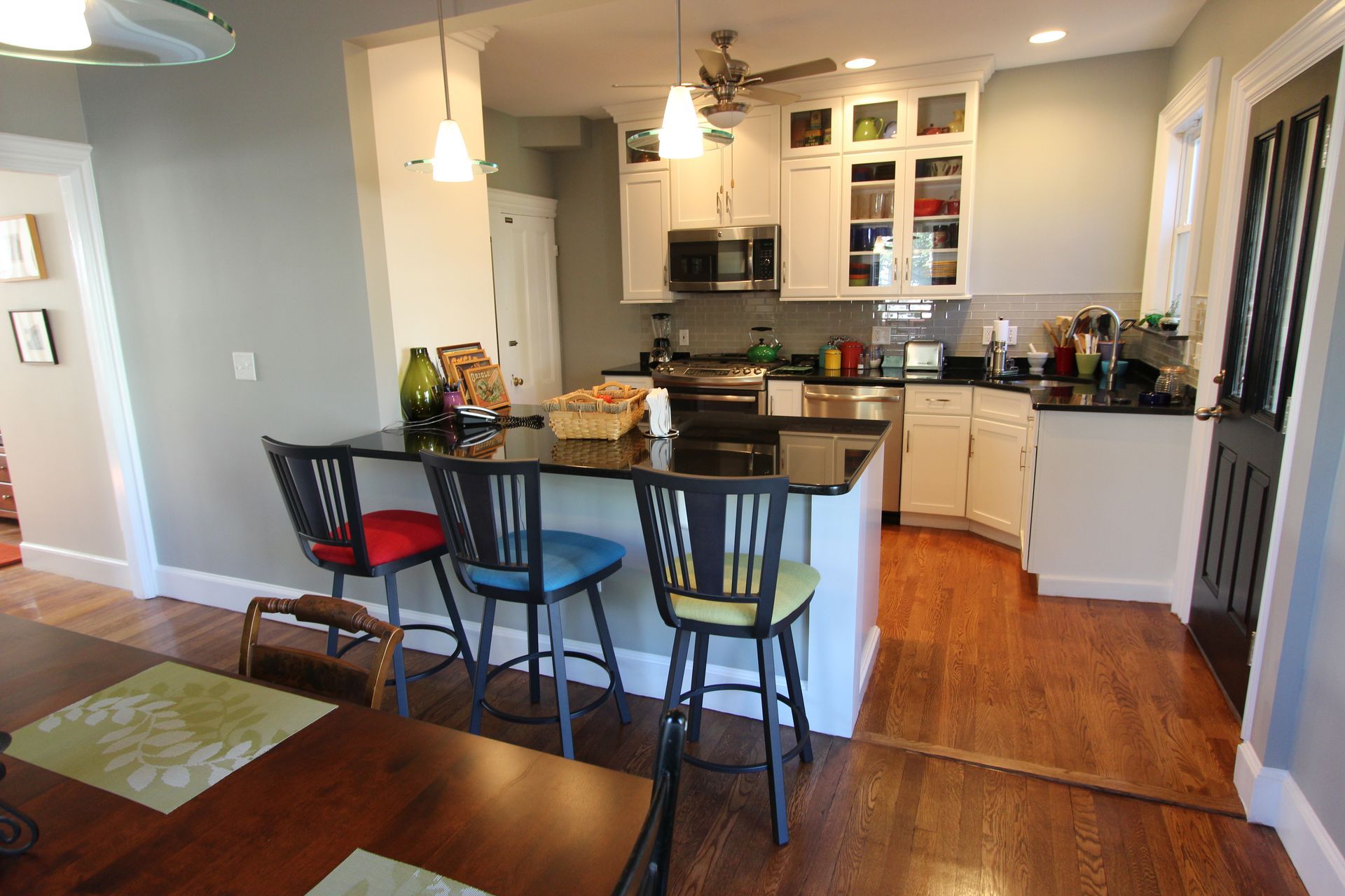 A kitchen with a table and chairs in it