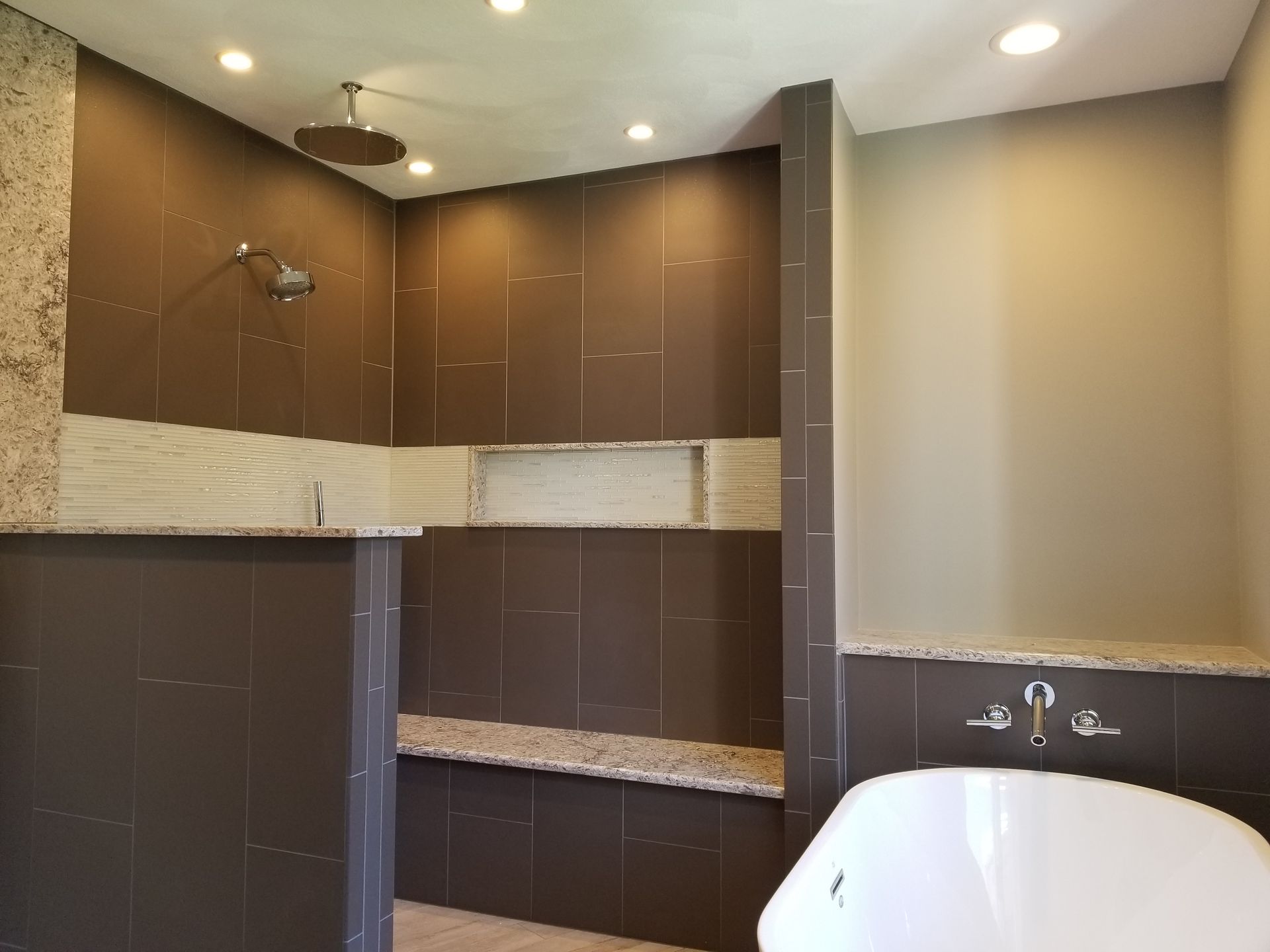 A bathroom with a tub and a walk in shower