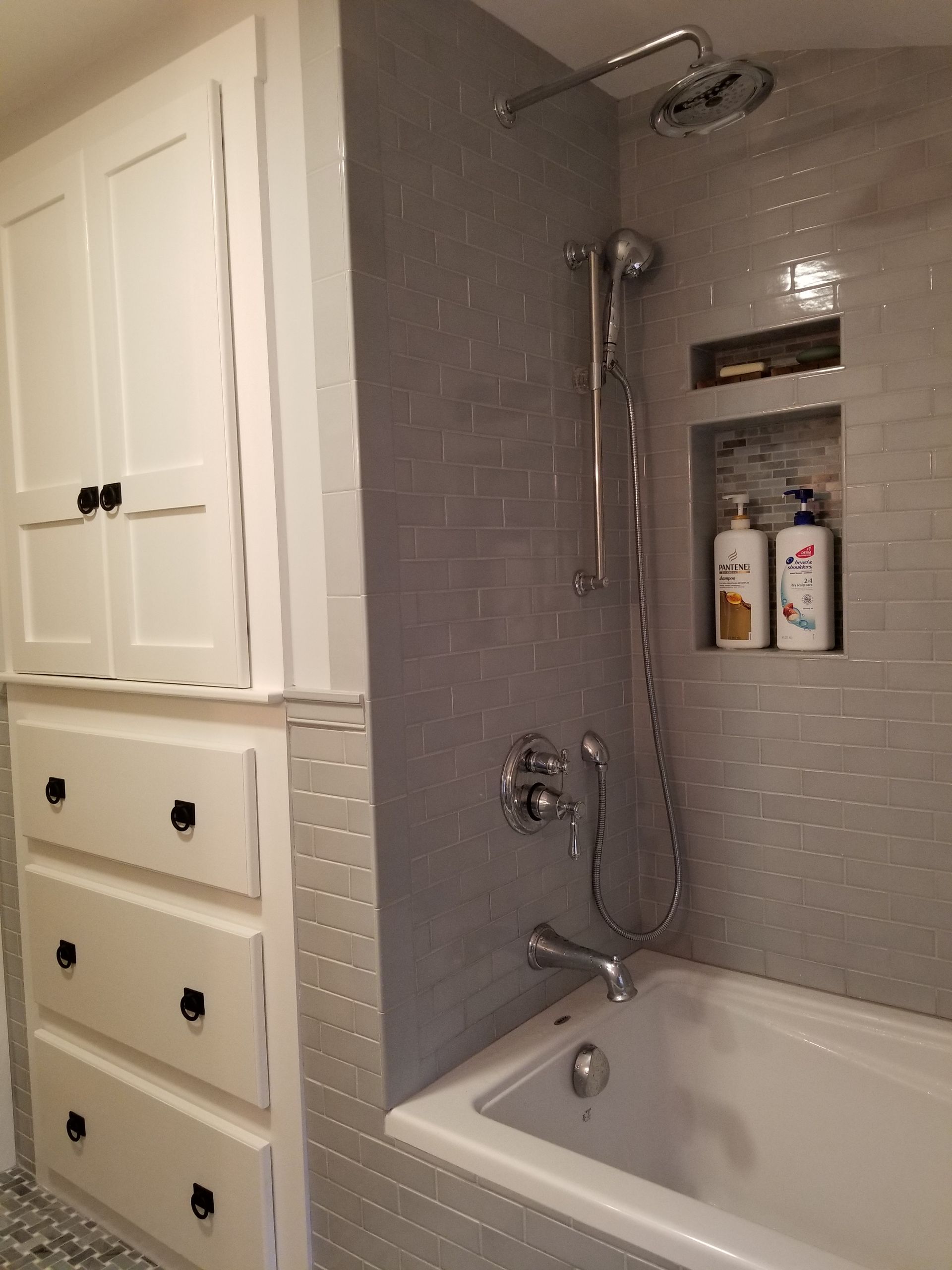 A bathroom with a bathtub and a shower.