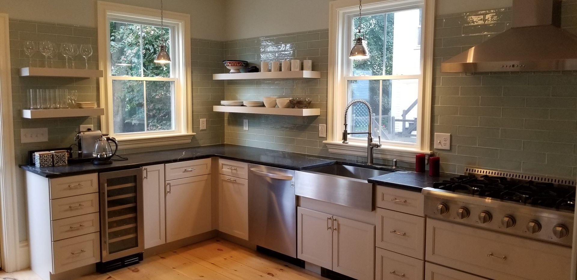 A kitchen with stainless steel appliances and white cabinets