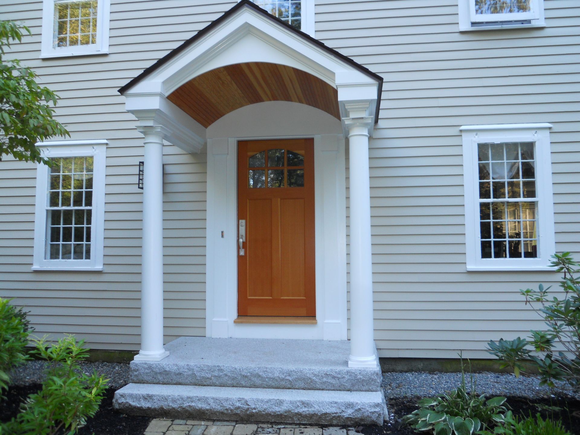 A house with a porch and a wooden door