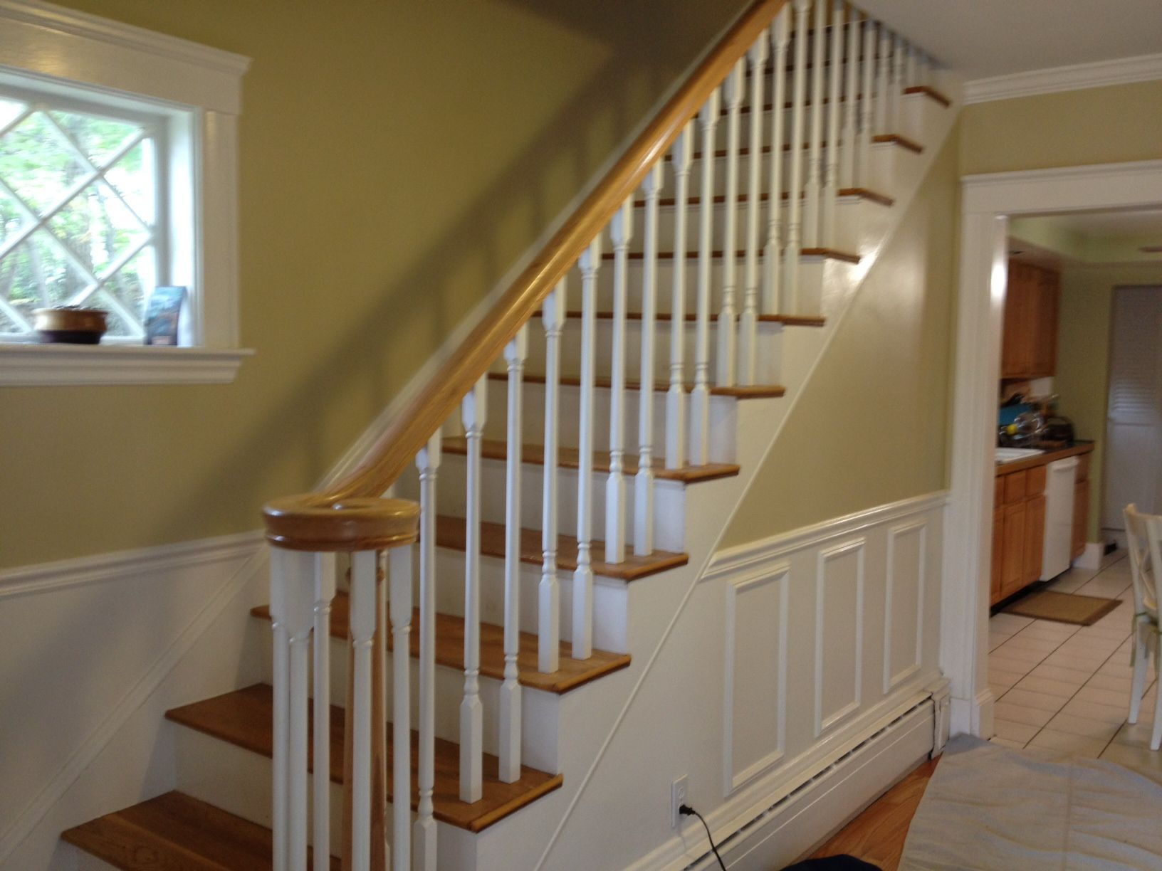 A staircase with white railings and wooden steps