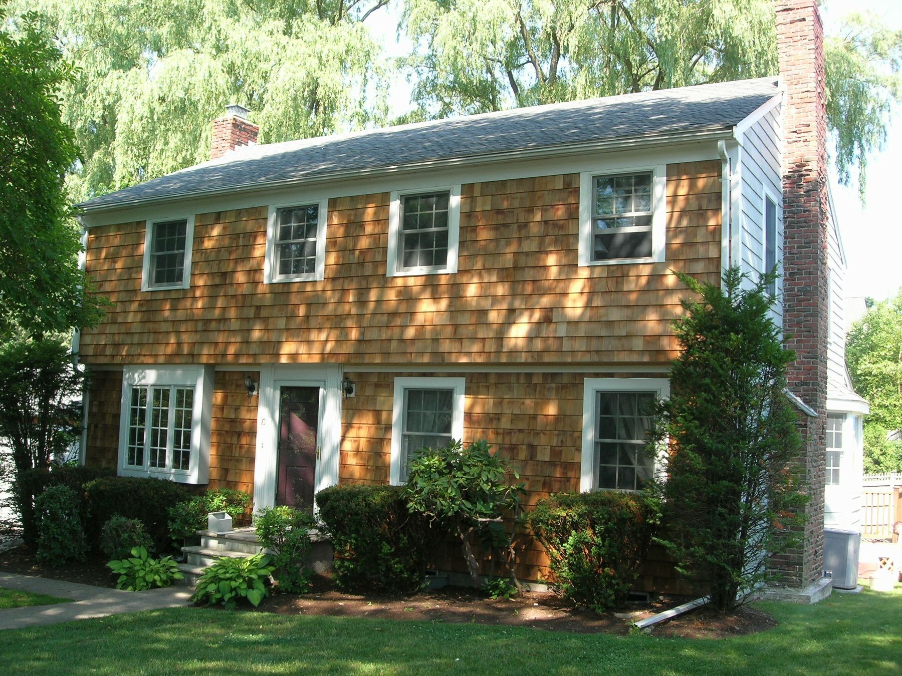 A house with a lot of windows and a chimney
