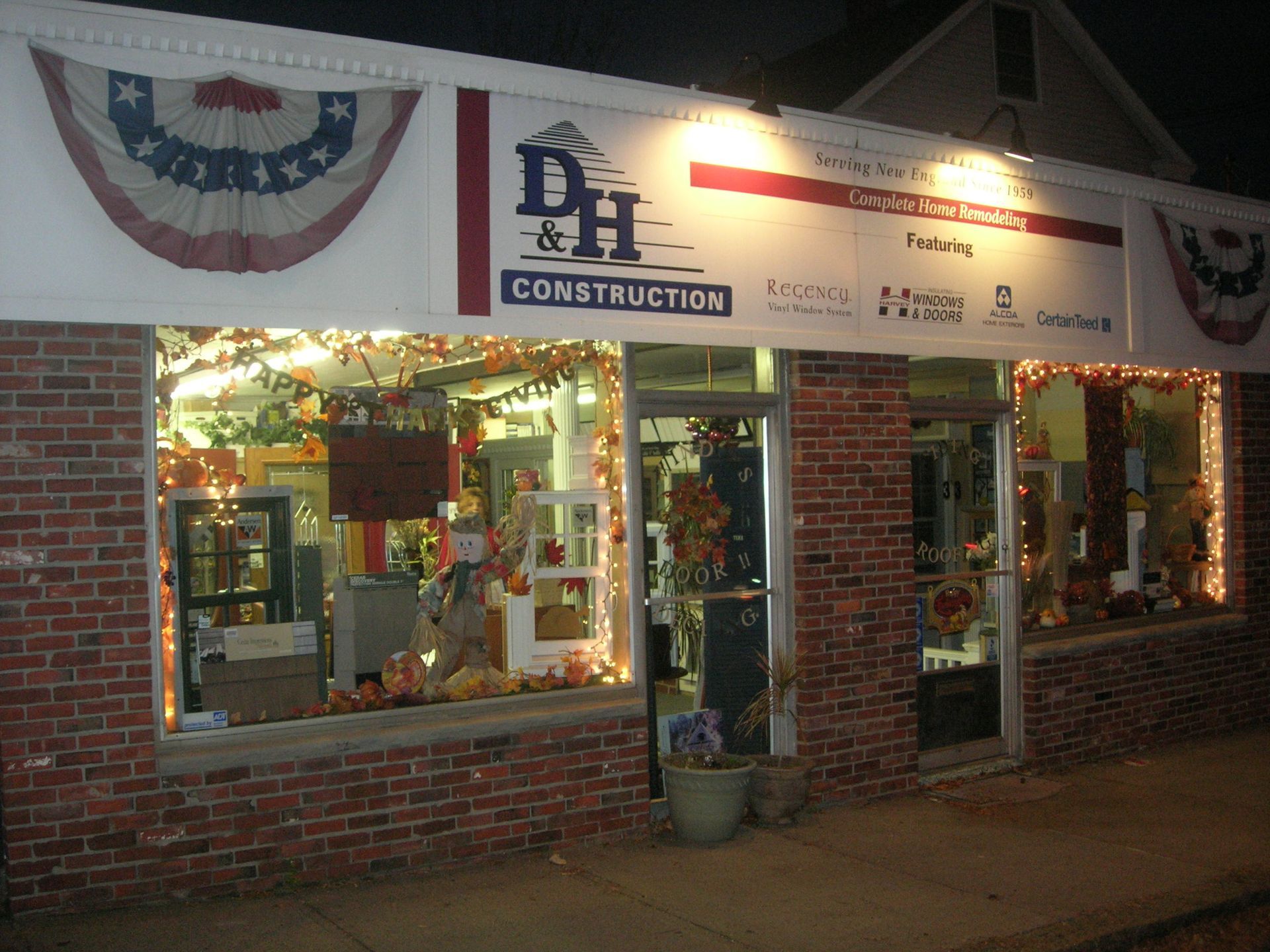 A brick building with a sign that says dh construction lo