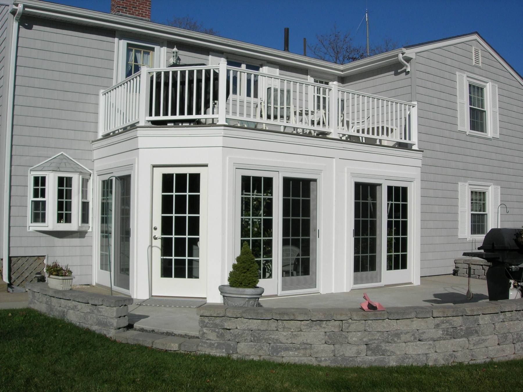 A house with a balcony and sliding glass doors