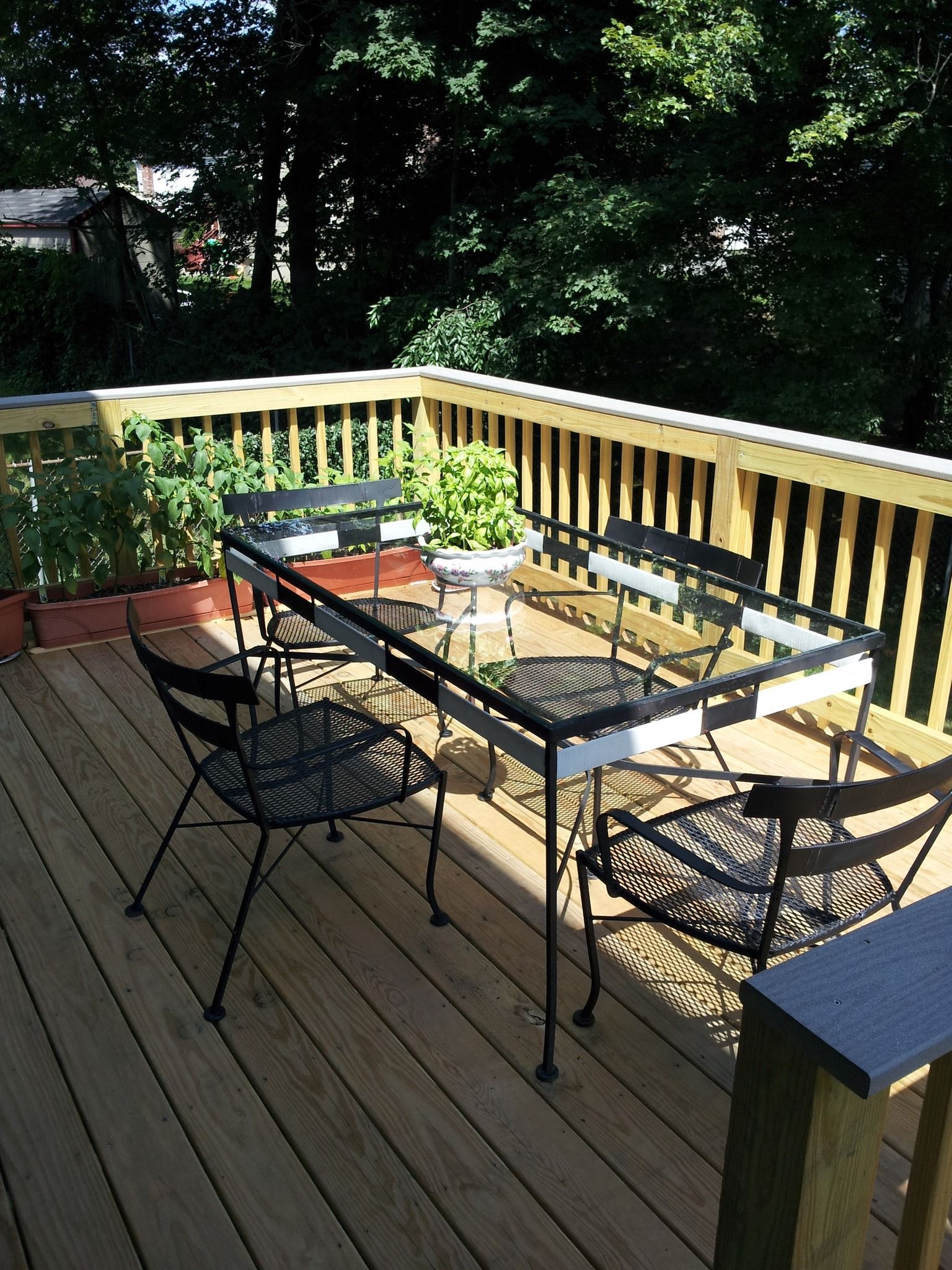 A wooden deck with a table and chairs on it