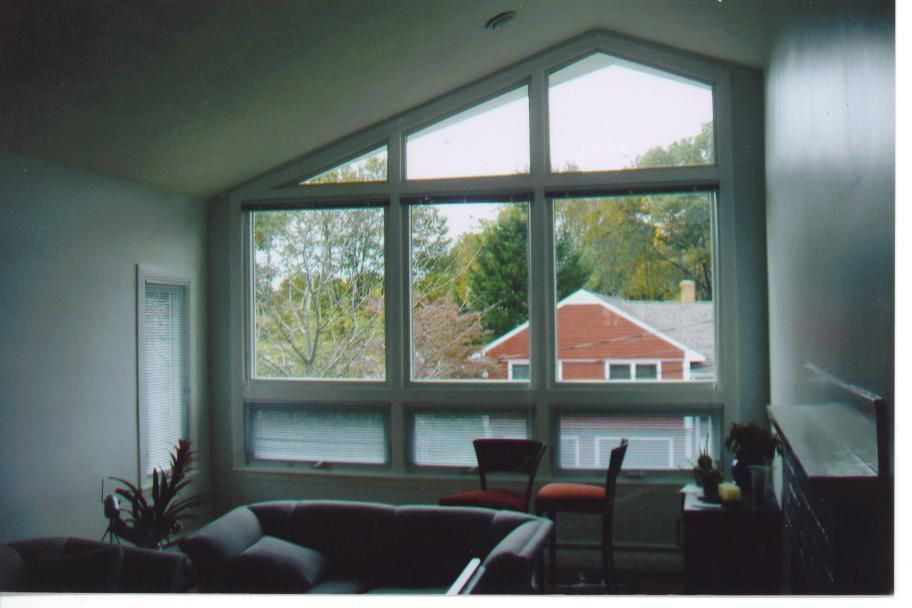 A living room with a lot of windows and a couch