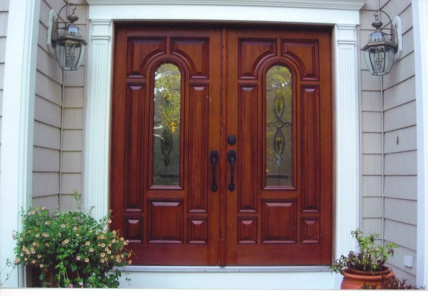 The front door of a house has a stained glass window