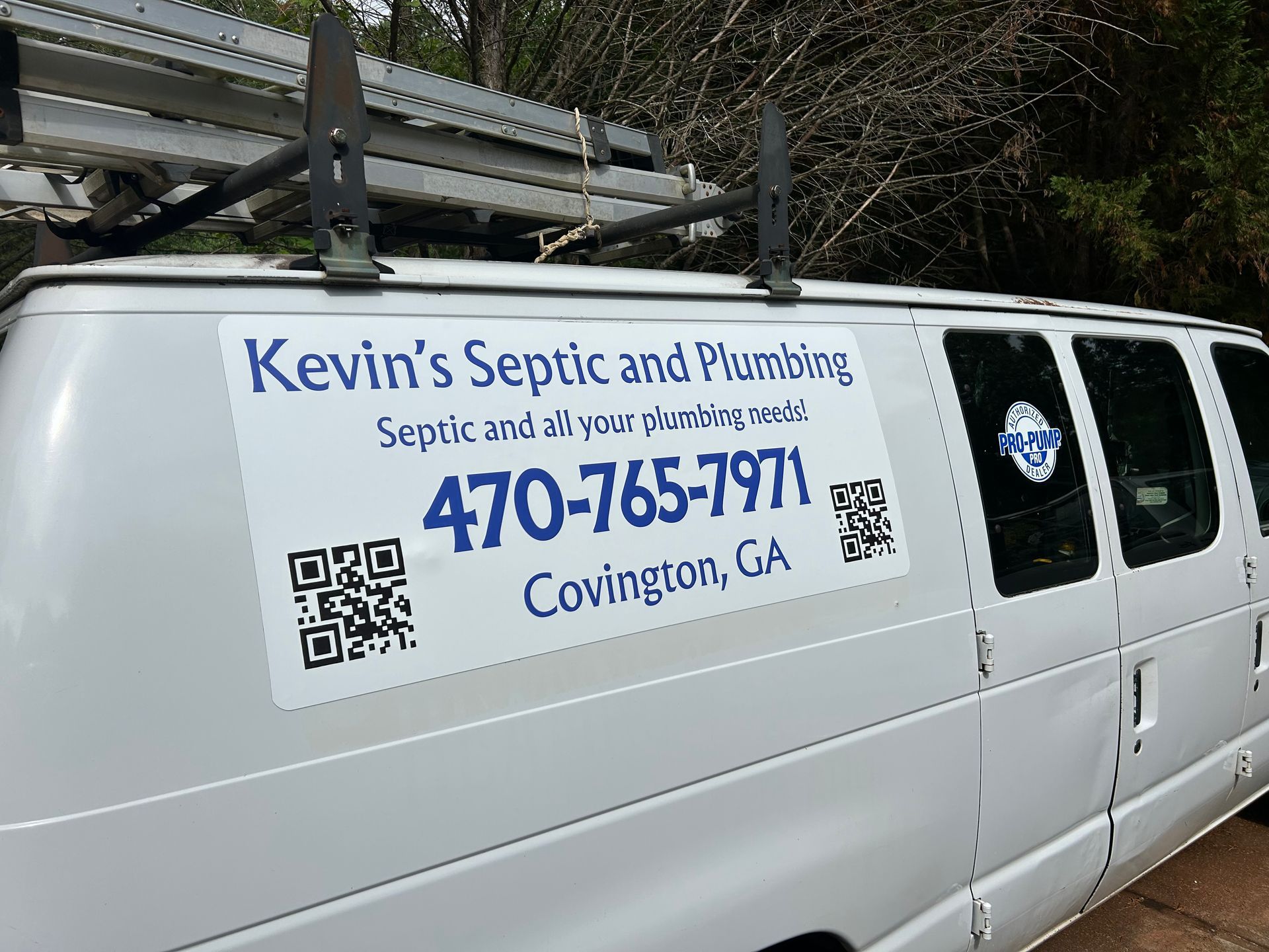 White van with Kevin's Septic and Plumbing signage, phone number, and QR codes; location Covington, GA.