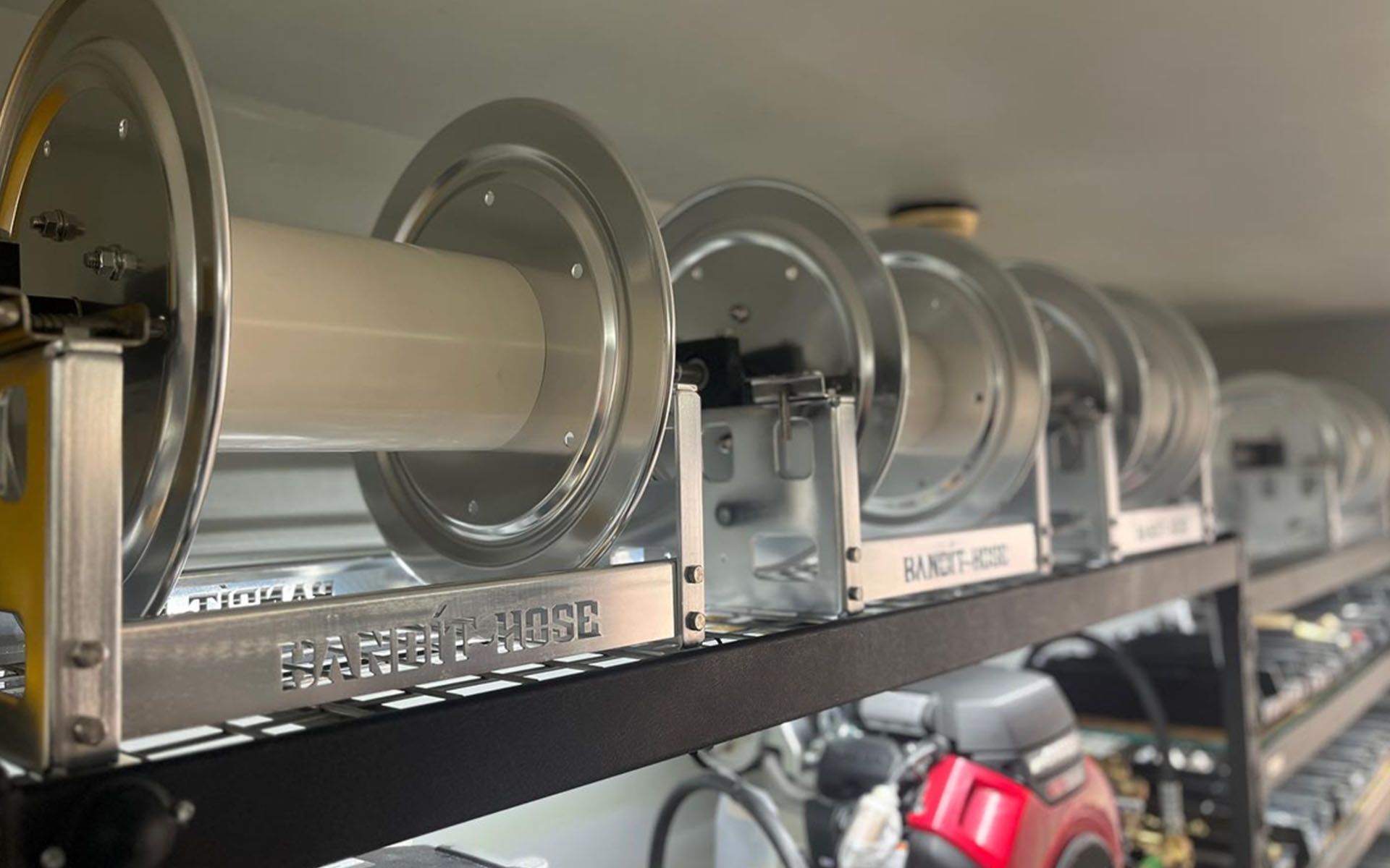 Shelf of clear cylindrical storage containers with metal lids in a store aisle