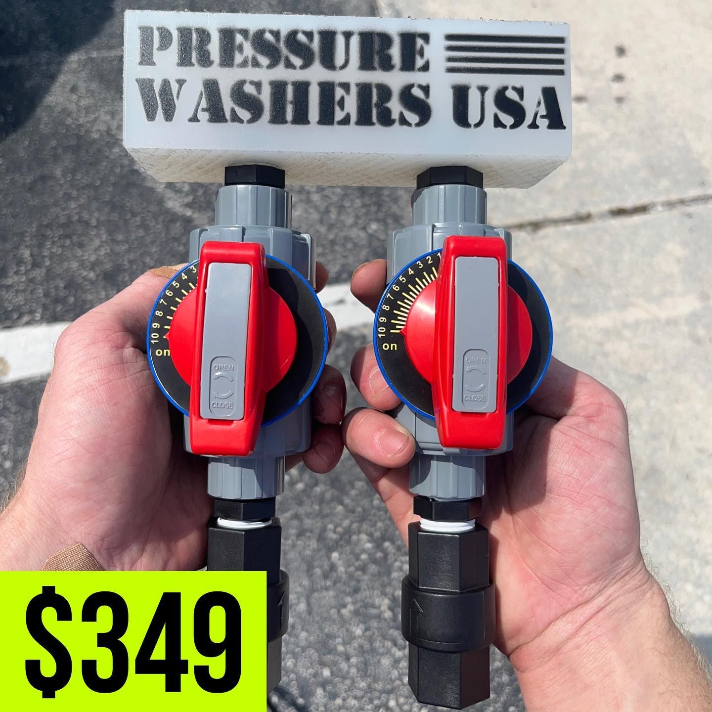 Two pressure washer spray gun handles held outdoors, with “PRESSURE WASHERS USA” sign and $349 price tag.