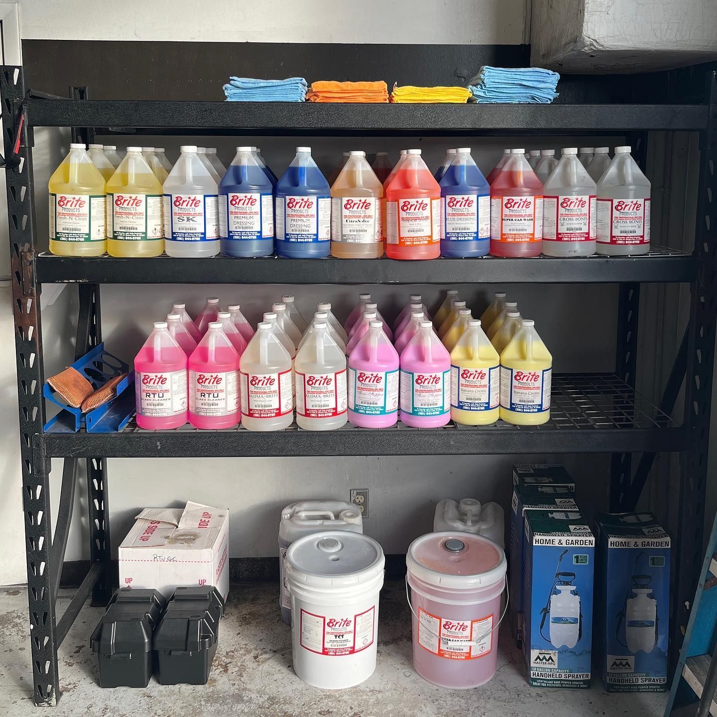 Shelves stocked with assorted cleaning chemicals and bottles in a storage area