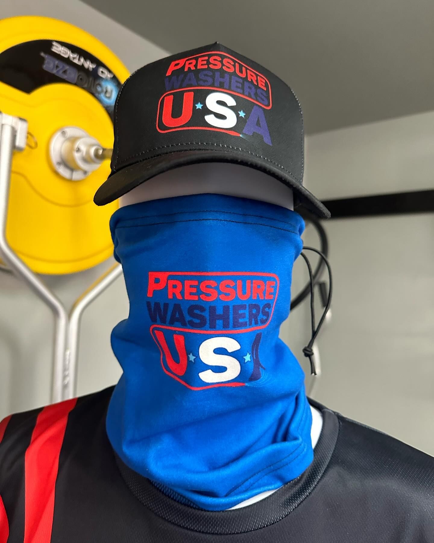 Person in black cap and blue face covering with 