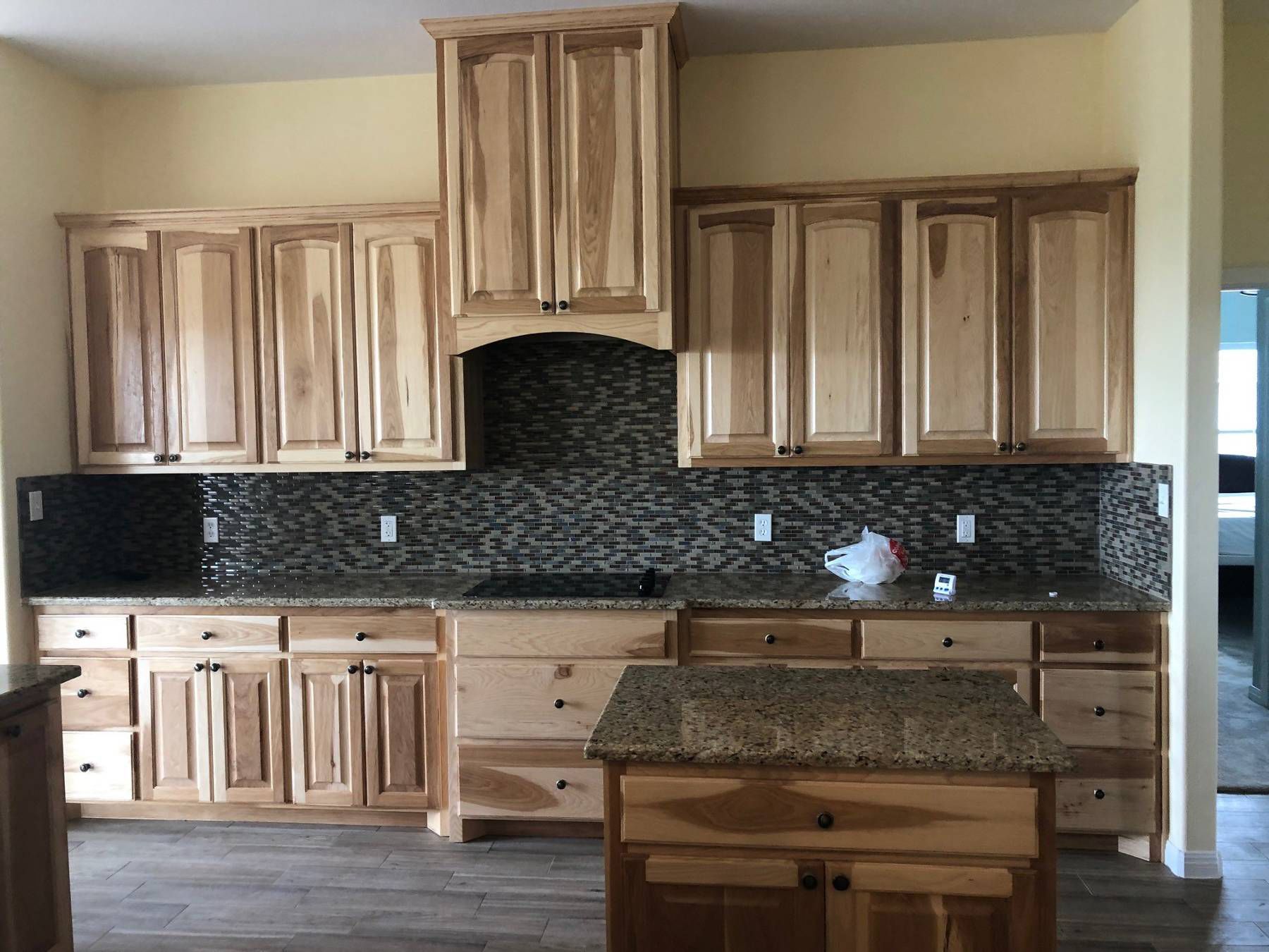 A kitchen with wooden cabinets and granite counter tops