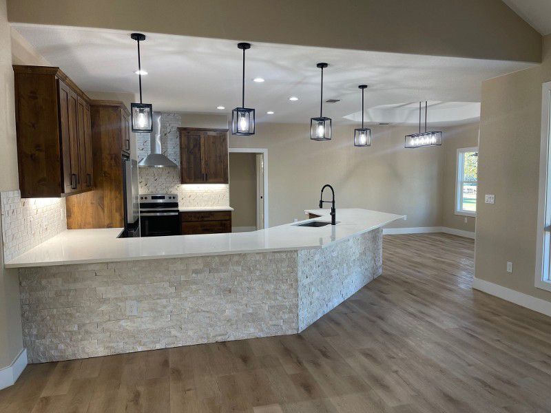 A kitchen with a large island in the middle of it
