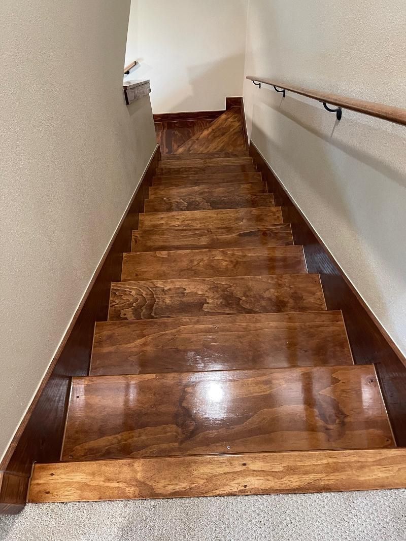 A set of wooden stairs leading up to the second floor of a house.