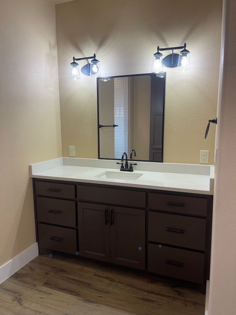 A bathroom with two sinks and a large mirror.