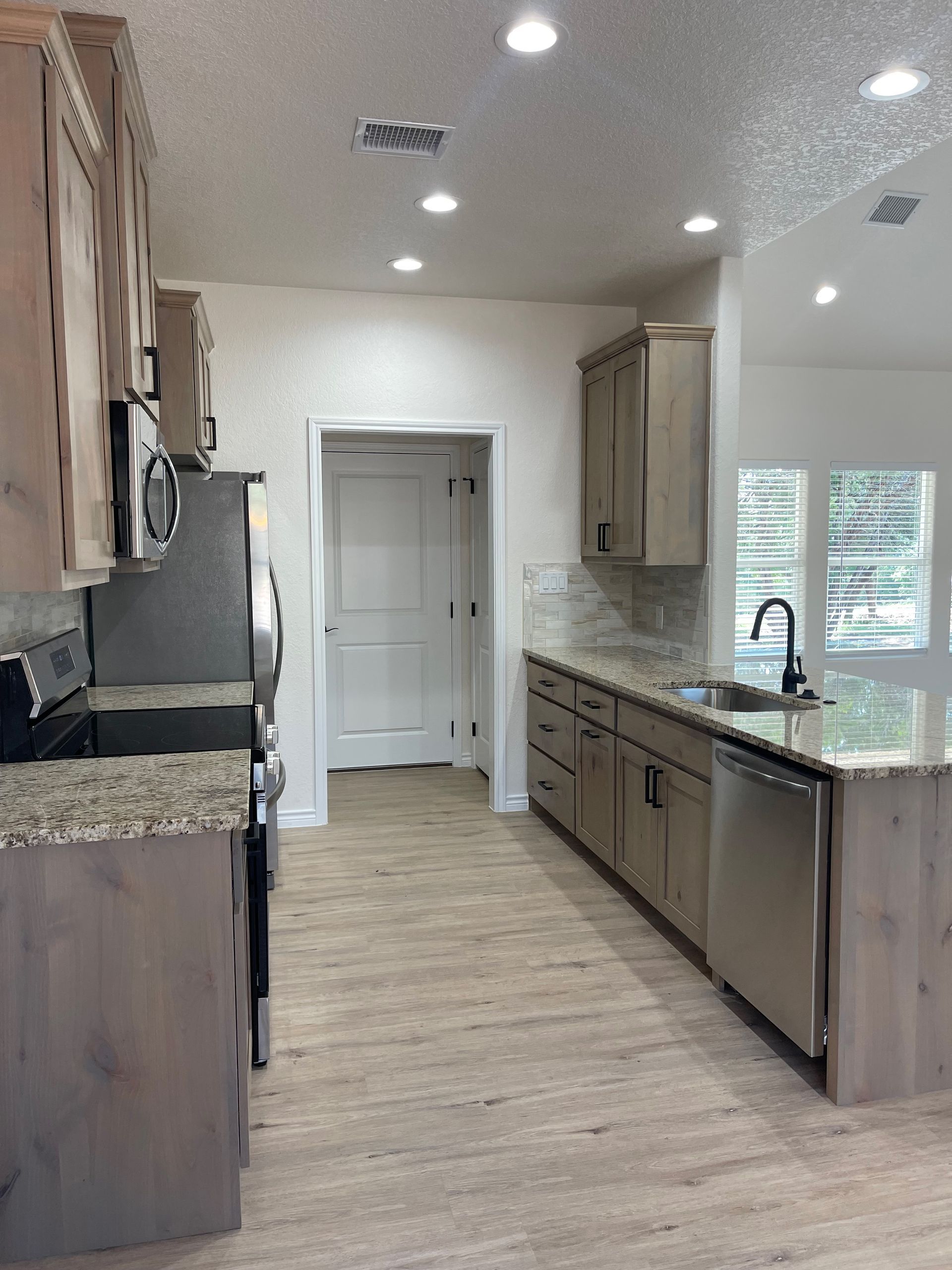 A kitchen with stainless steel appliances and granite counter tops