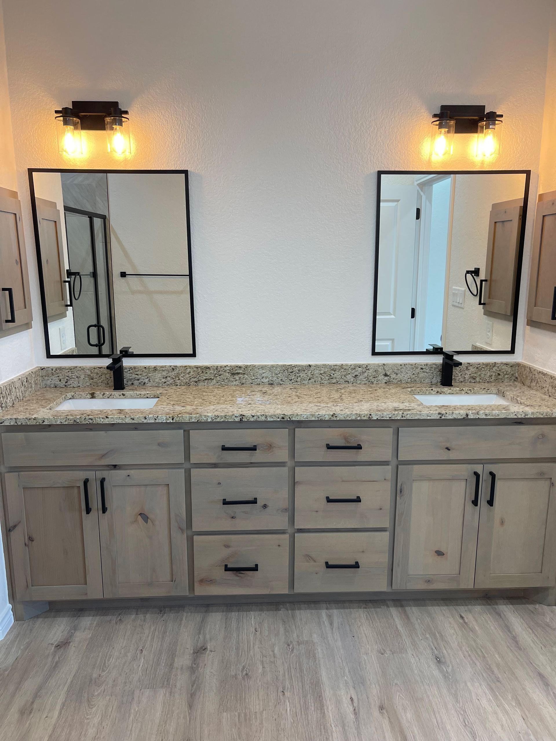 A bathroom with two sinks and two mirrors.