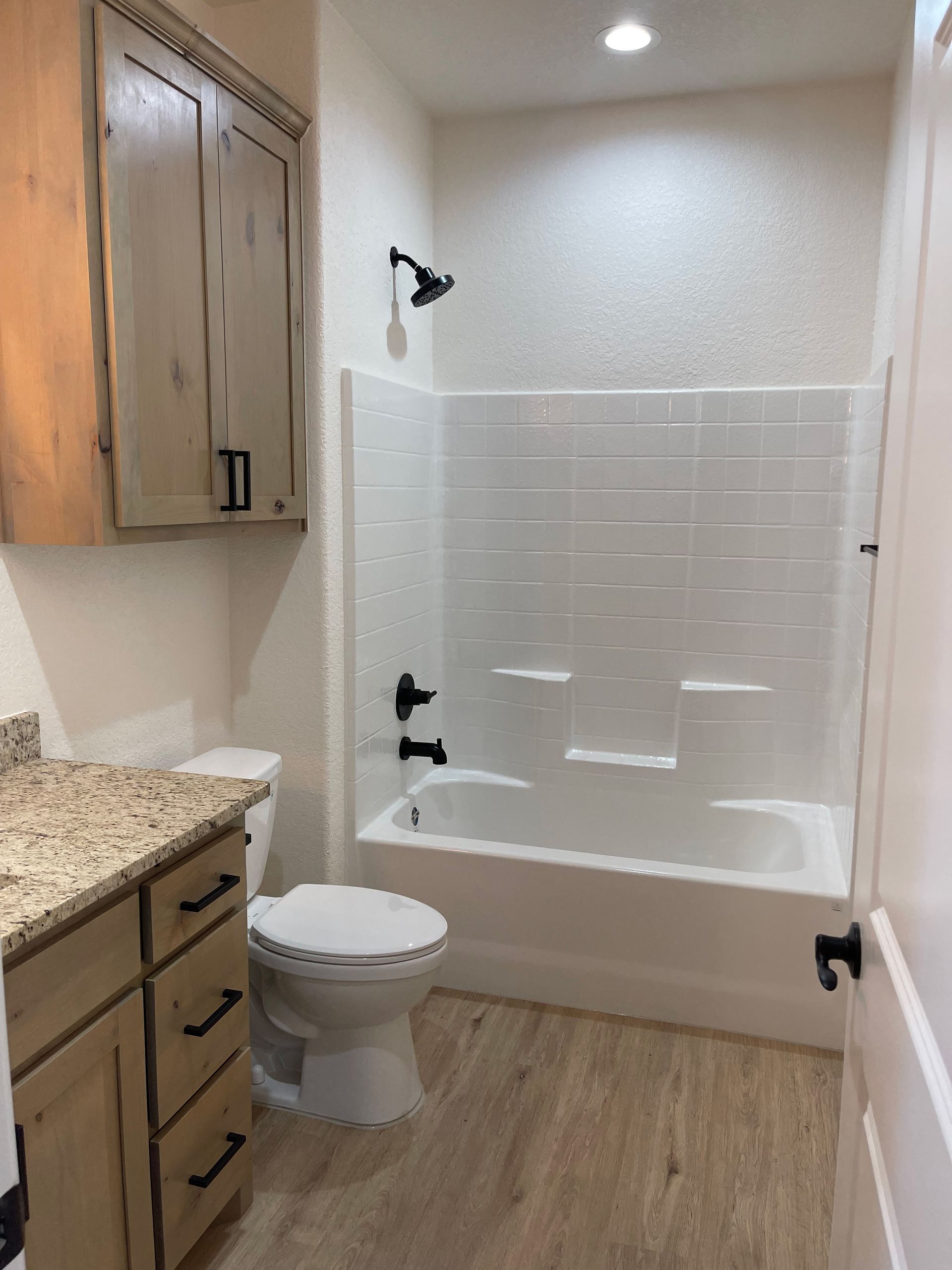 A bathroom with a toilet a sink and a bathtub