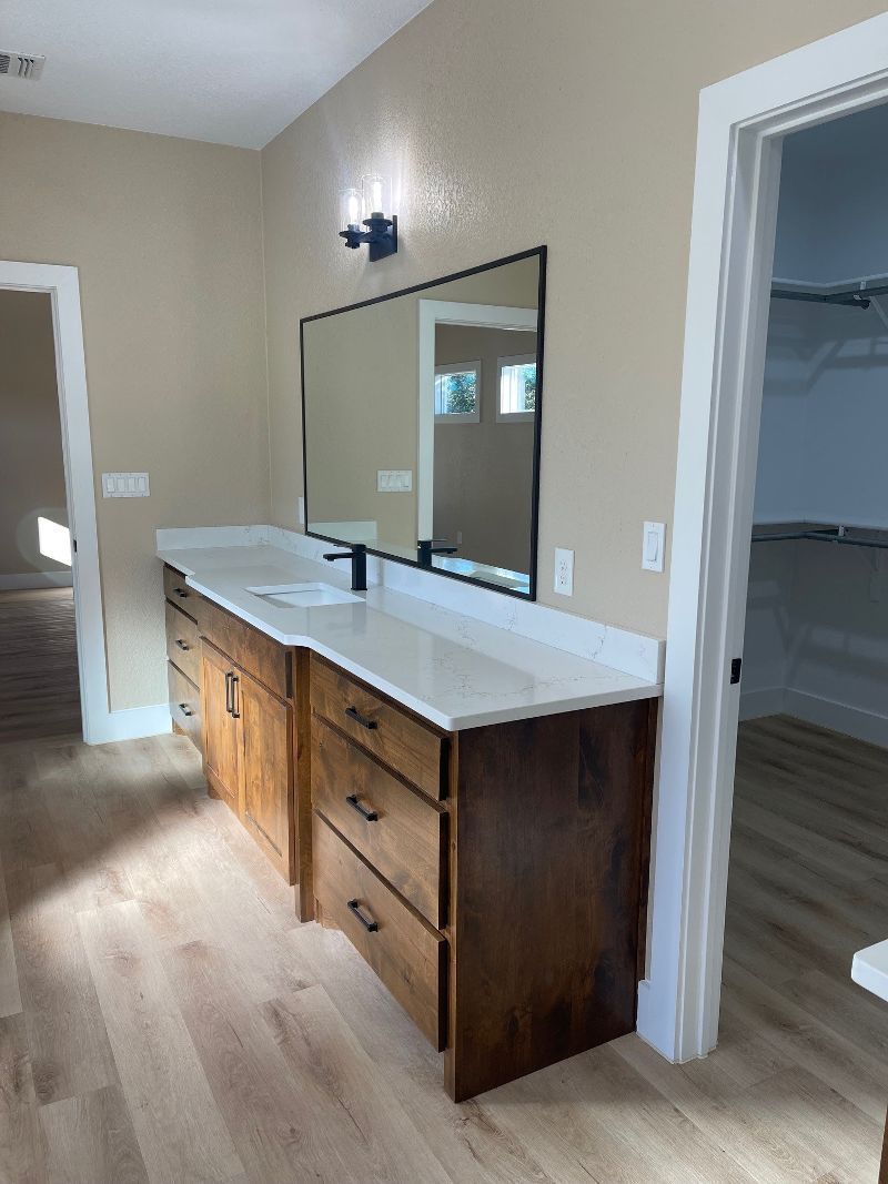 A bathroom with two sinks and a large mirror.