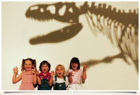 Children with dinosaur shadow on the back