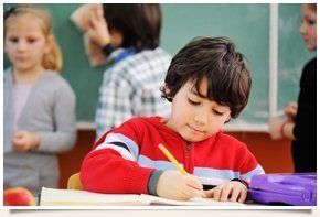 Little boy writing on a piece of paper