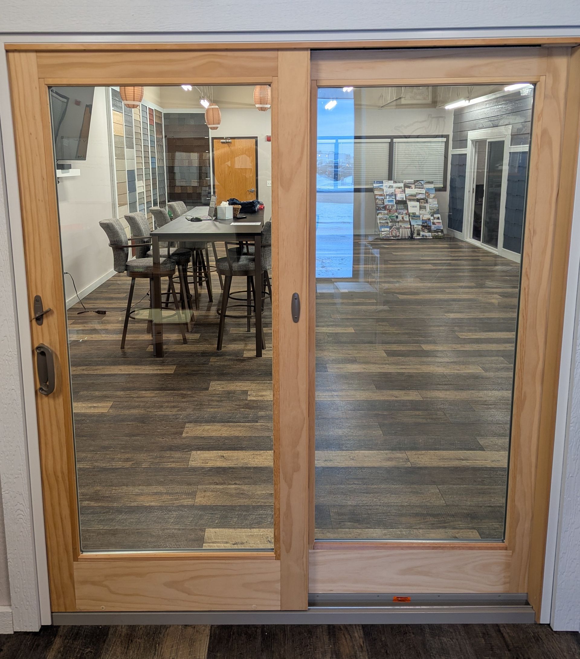A sliding glass door leading to a room with a table and chairs