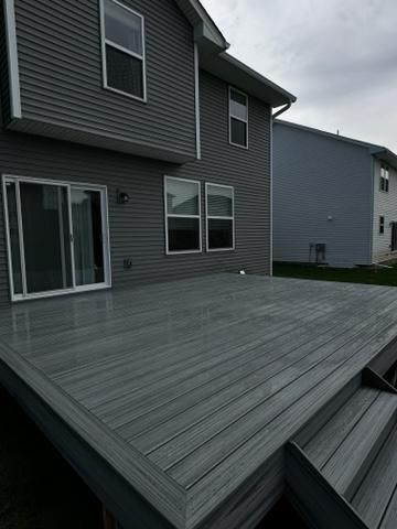 A house with two garbage cans in front of it.
