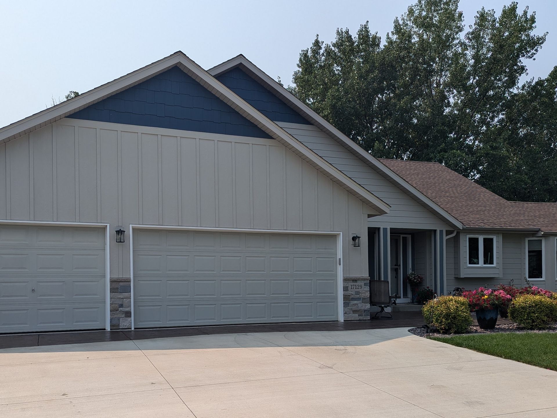 A house with three garage doors and a driveway
