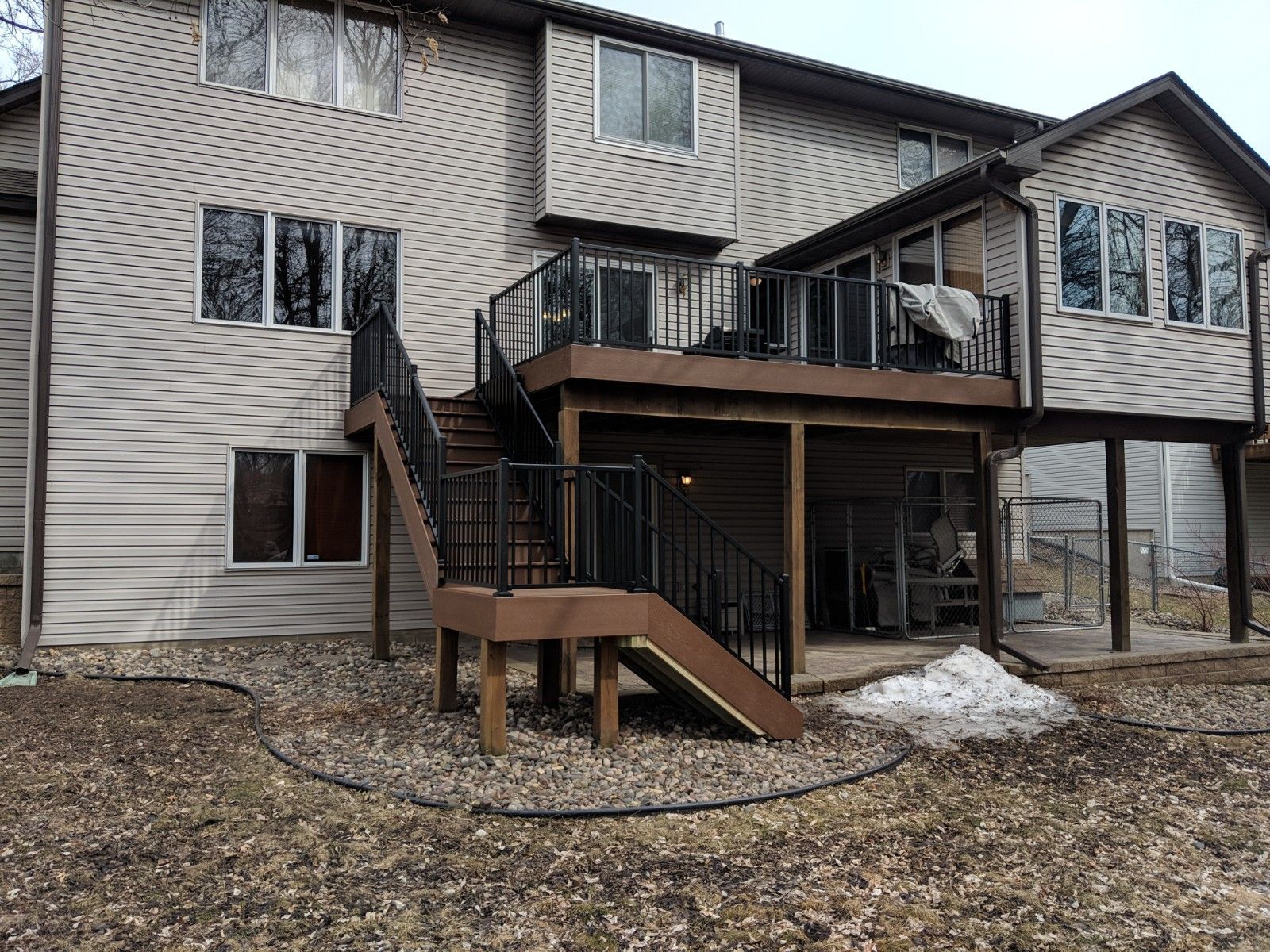 The back of a house with a deck and stairs.