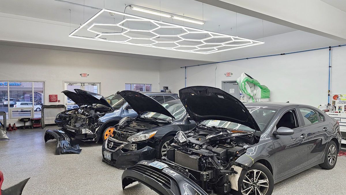 A row of cars with their hoods open
