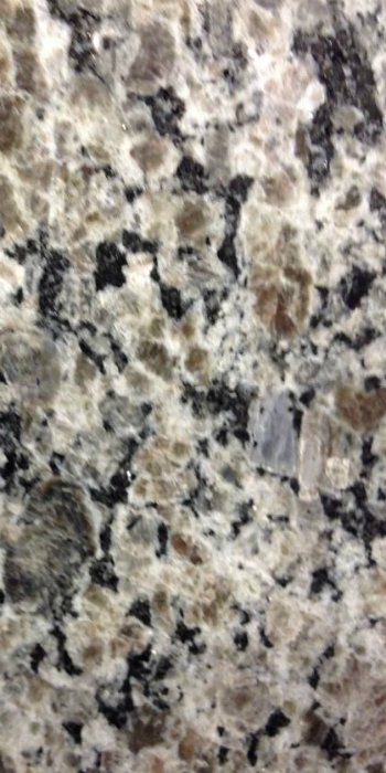 A close up of a granite counter top with black and white spots.