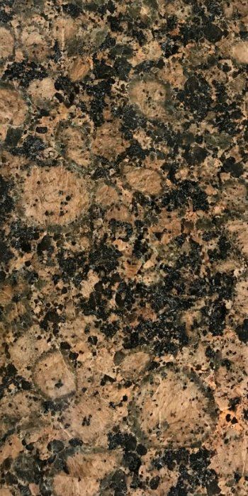 A close up of a brown and black granite counter top.