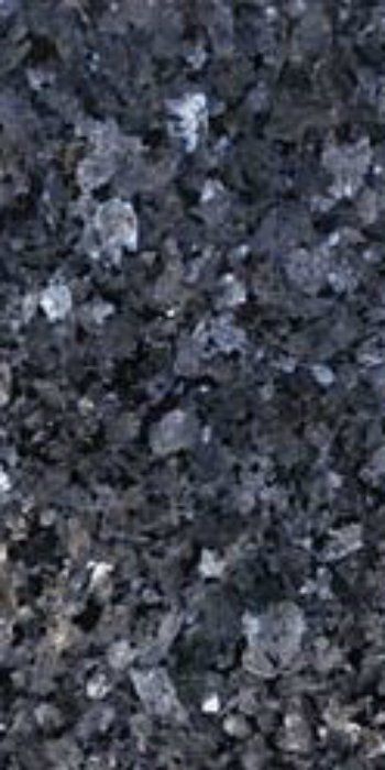 A close up of a pile of black rocks on the ground.