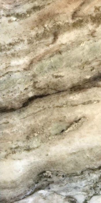 A close up of a piece of wood with a marble texture.