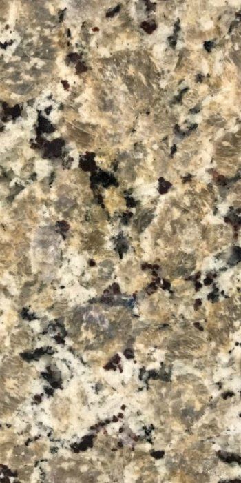 A close up of a brown and white granite counter top.