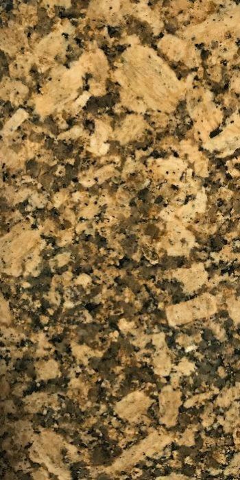 A close up of a brown and black granite counter top.