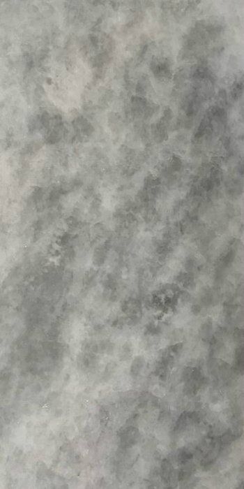 A close up of a gray and white marble texture.
