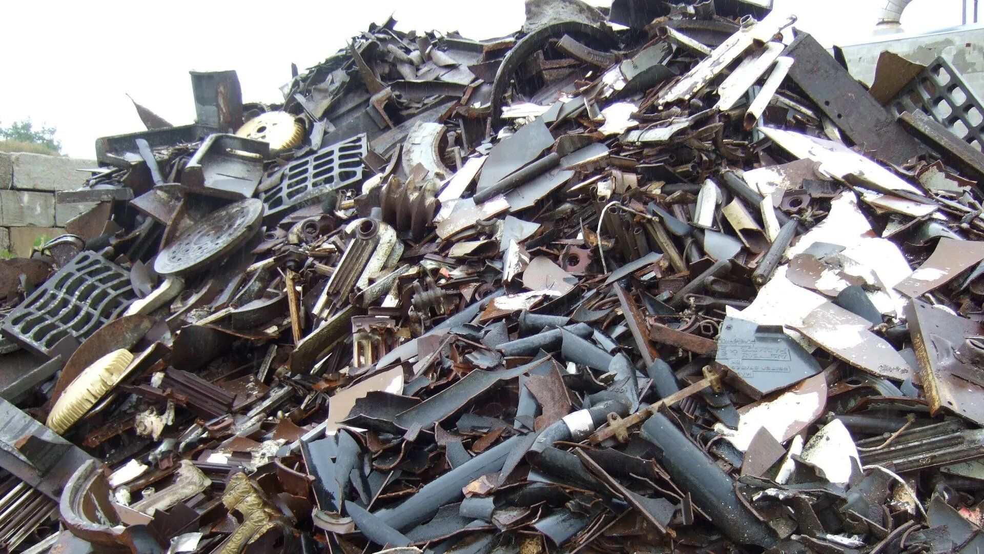 Pile of twisted metal scrap and debris at a junkyard or demolition site