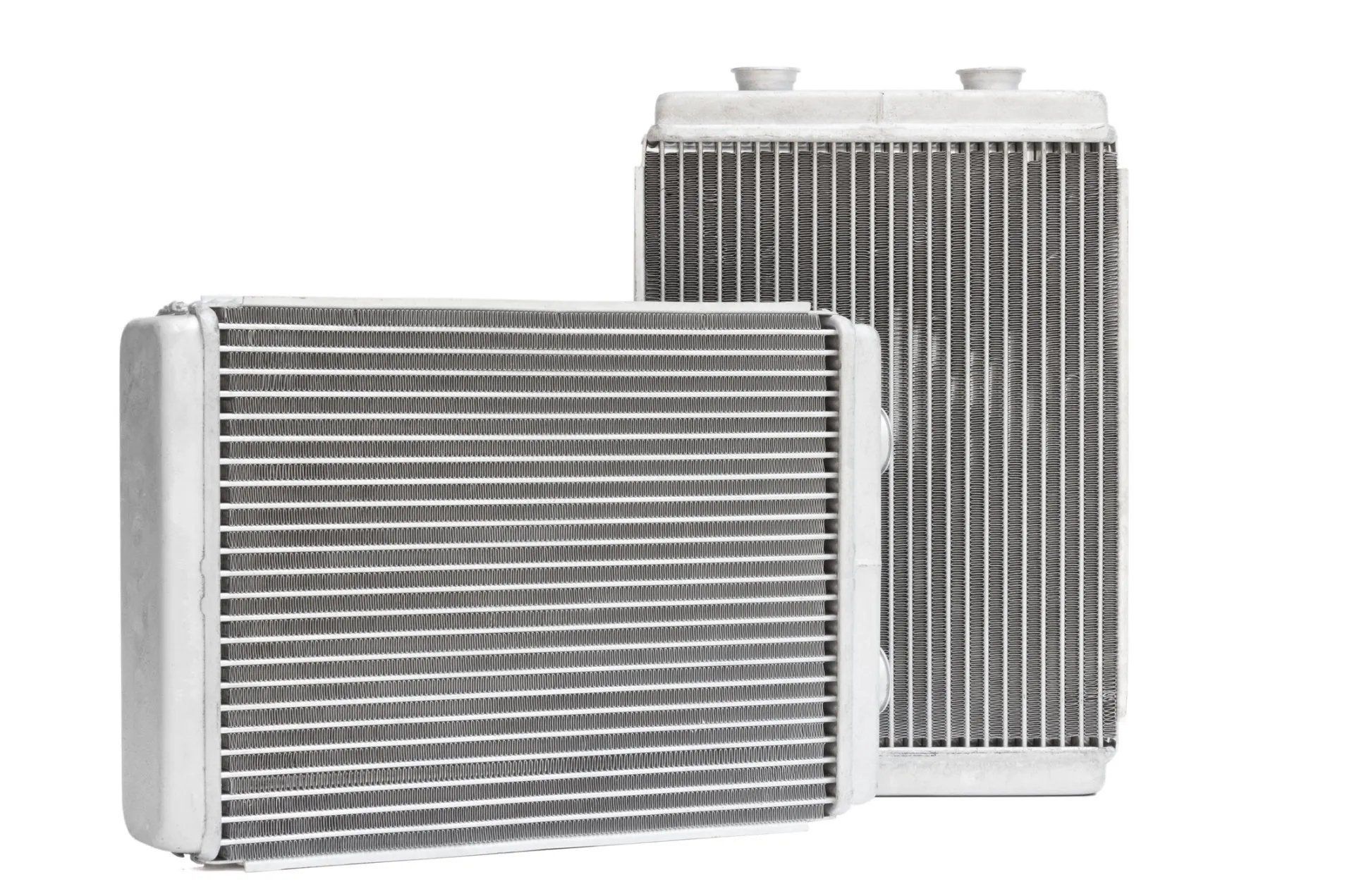 Two white automotive radiator/heater cores on a white background