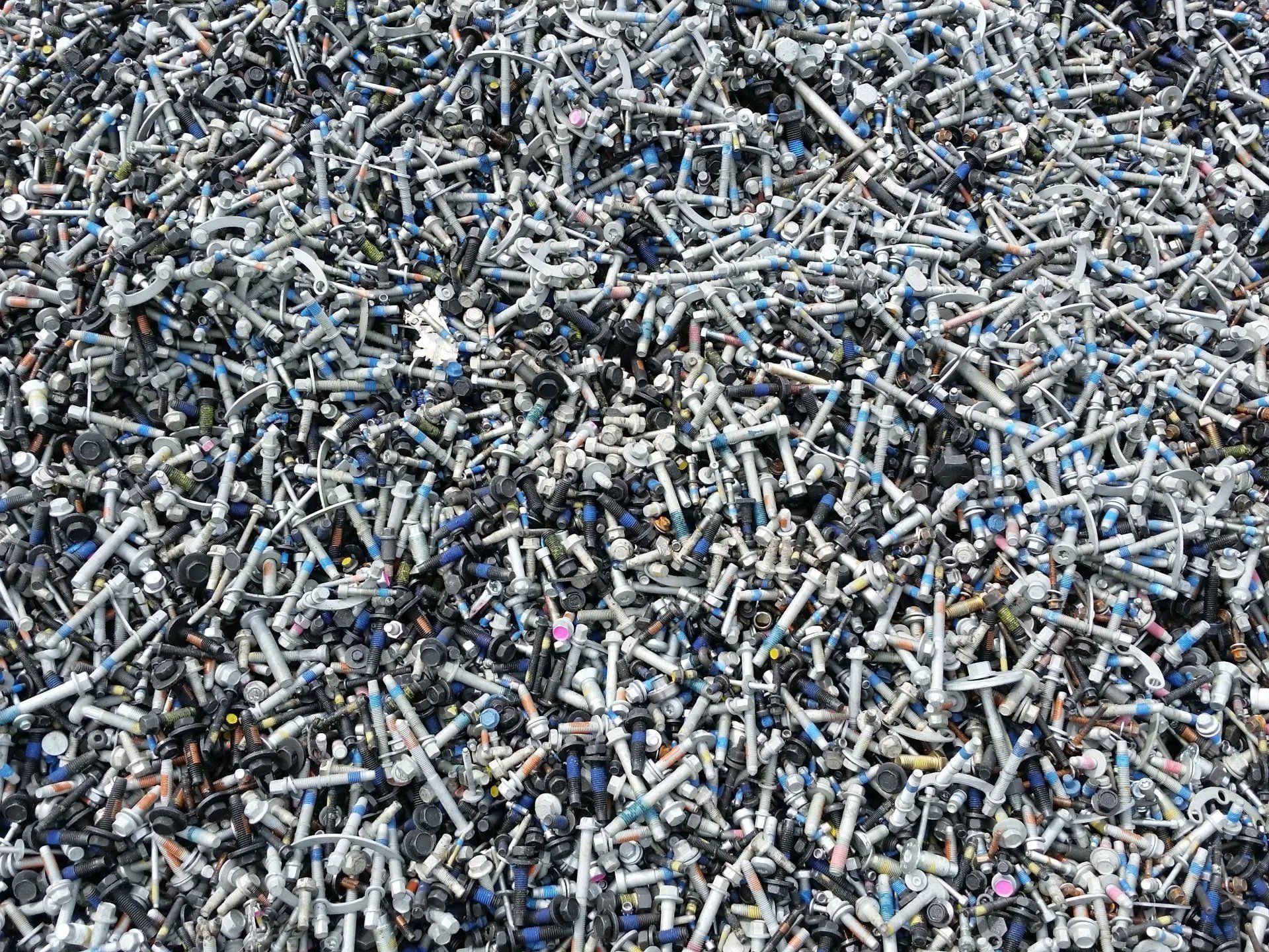 A pile of crushed aluminum cans and metal scrap filling the frame