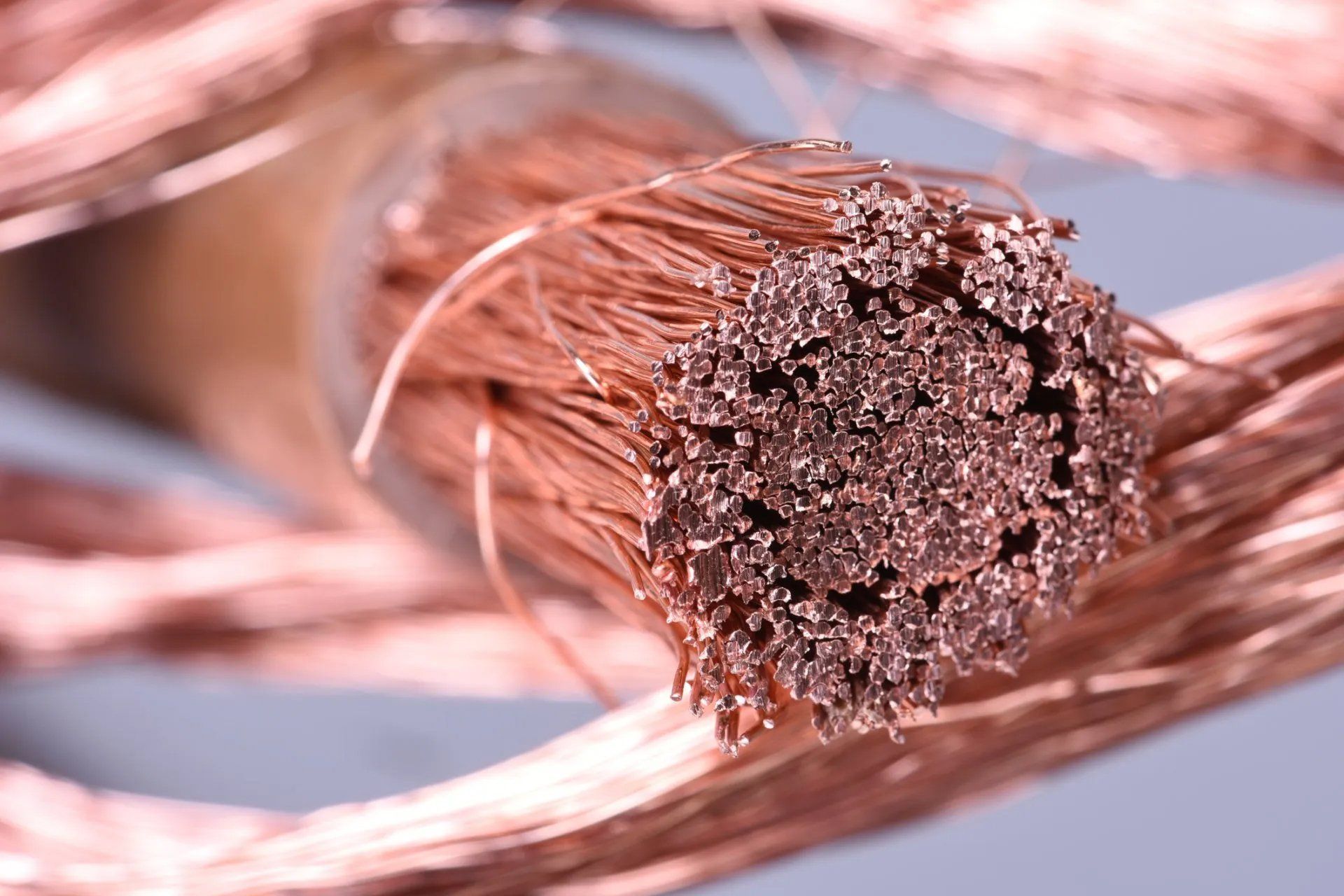 Close-up of exposed copper electrical cable strands with a frayed, cut end