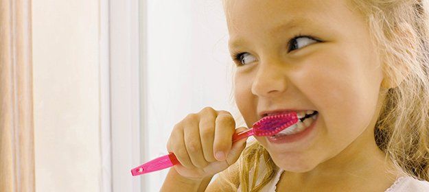 Little girl brushing her teeth