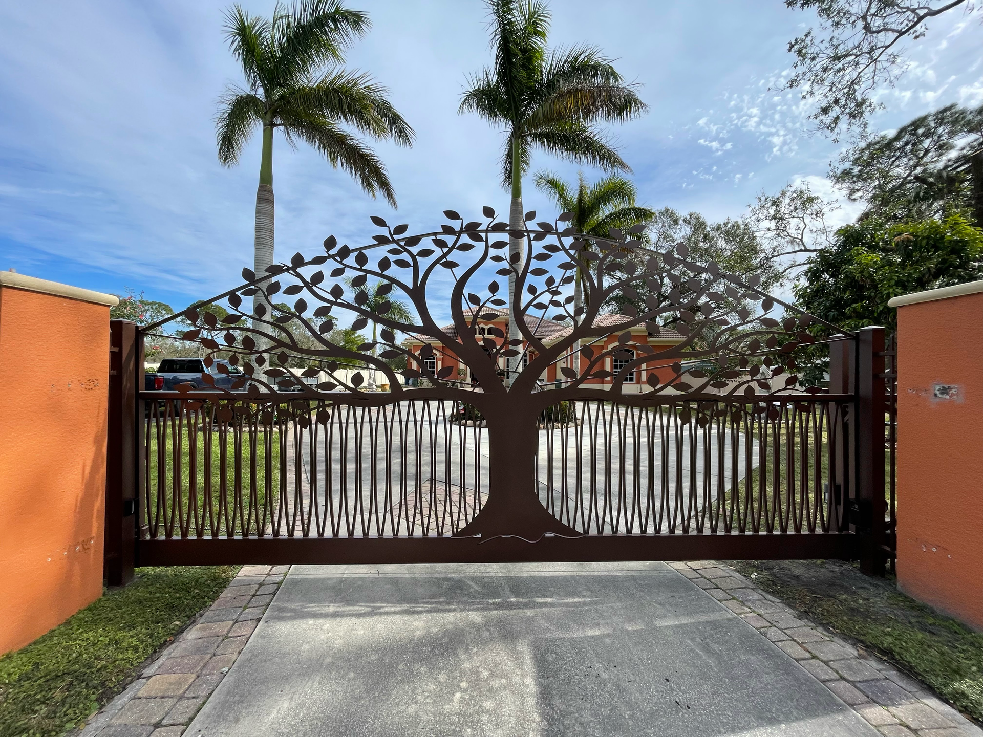 A sliding gate with a tree design on it.
