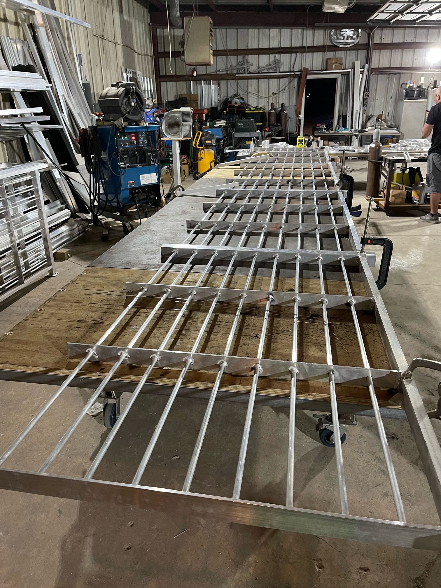 A metal fence is being built in a factory.